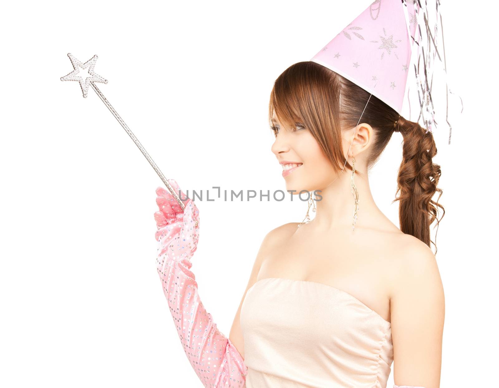 happy girl in party cap with magic stick