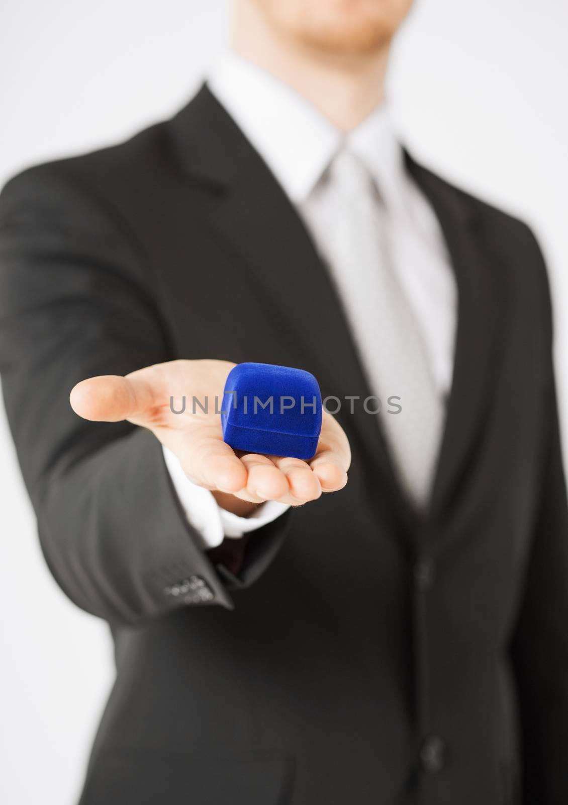 picture of man with gift box in suit