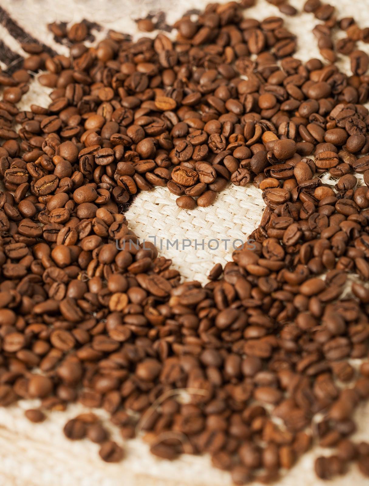 close up of coffee beans on the textile background