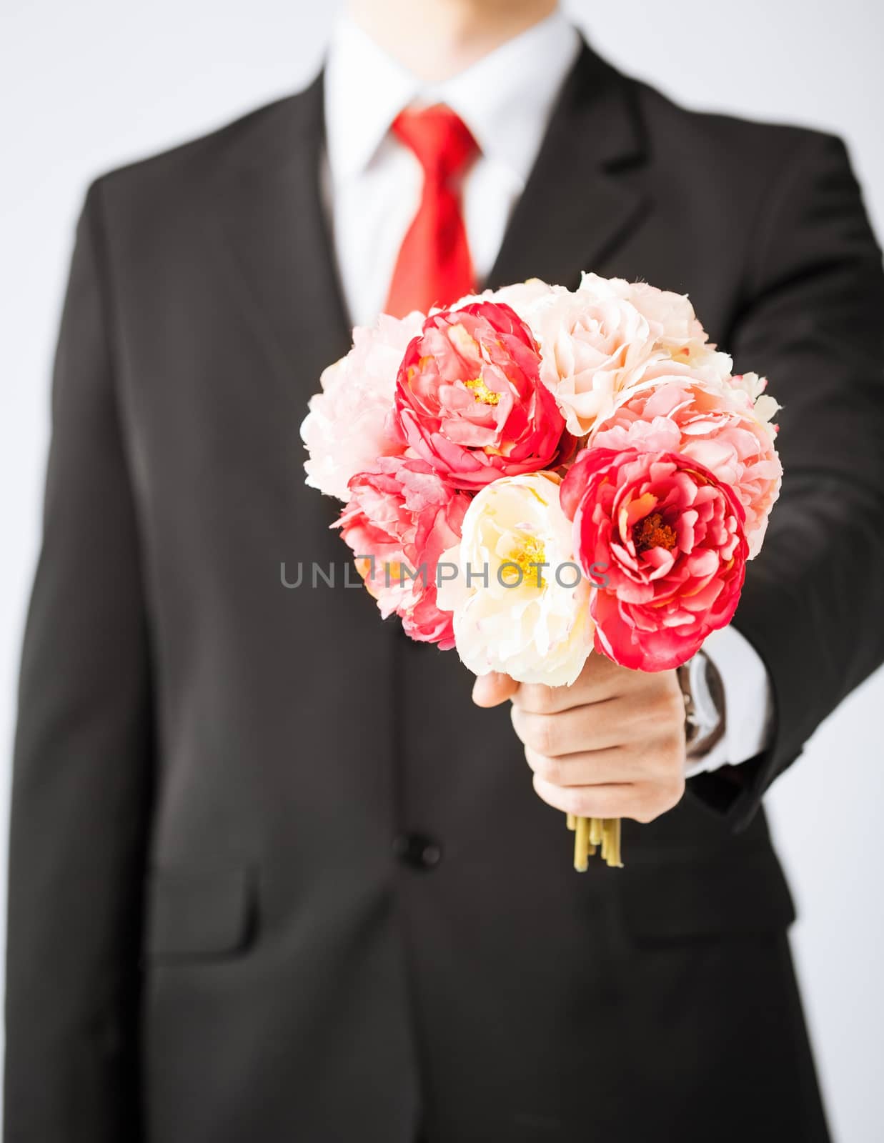 man giving bouquet of flowers by dolgachov