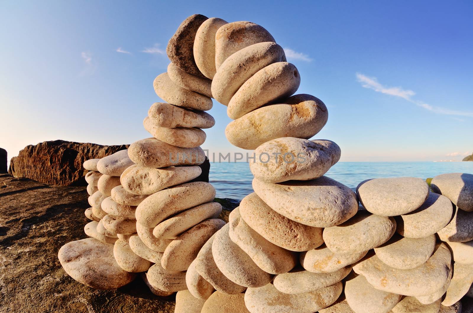 Stone arch between the pebbles on the coast