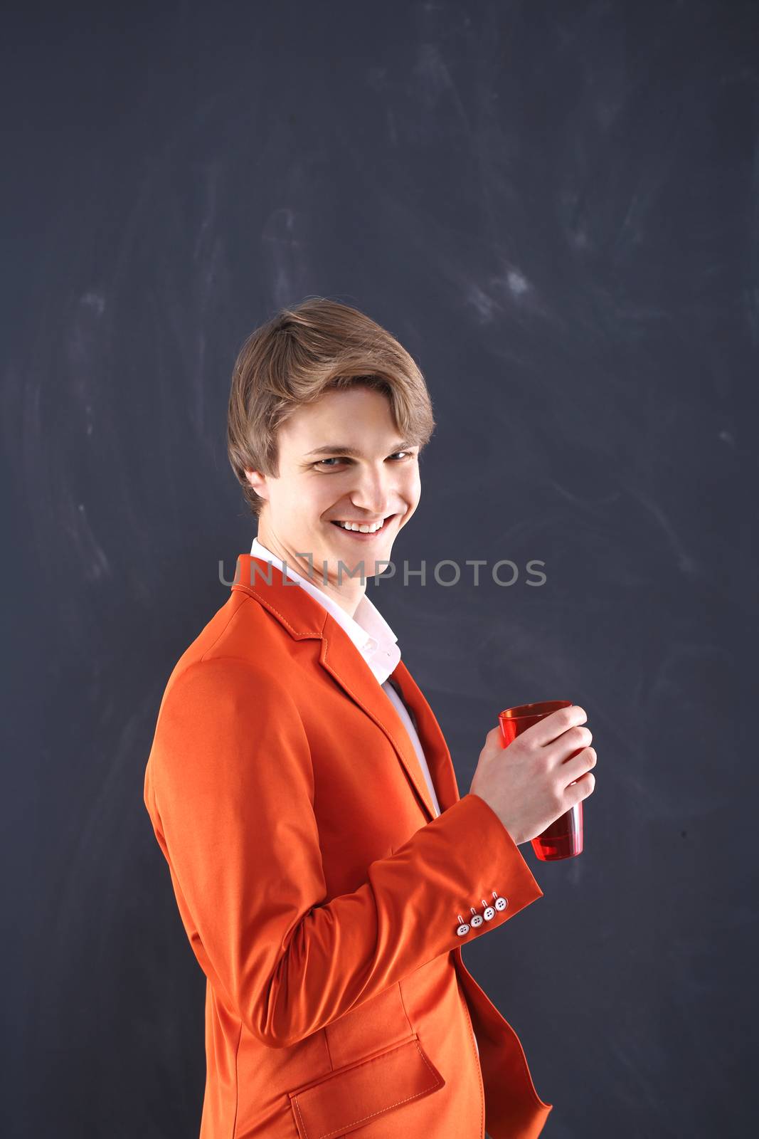 Smiling young worker with red mug