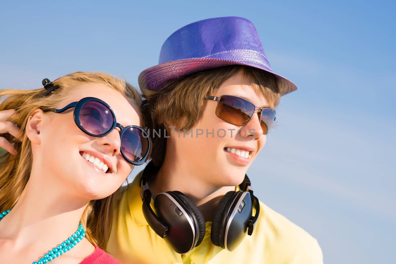 young couple standing on the road, having fun with friends