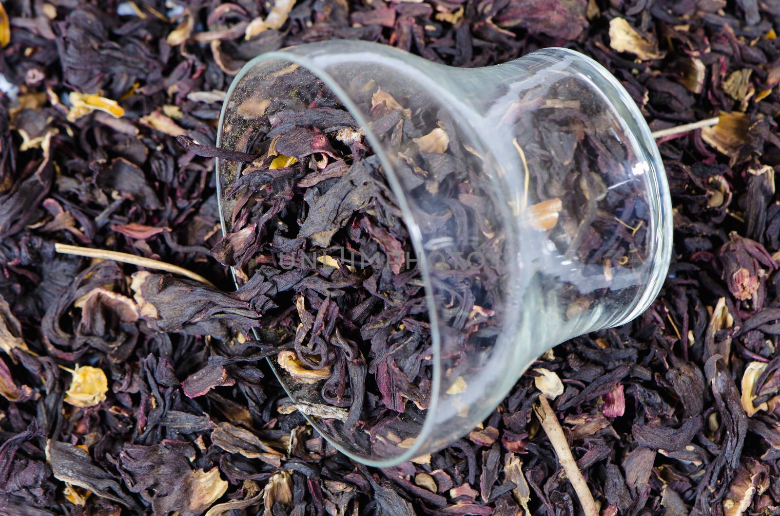 black tea herbal pile and glass cup