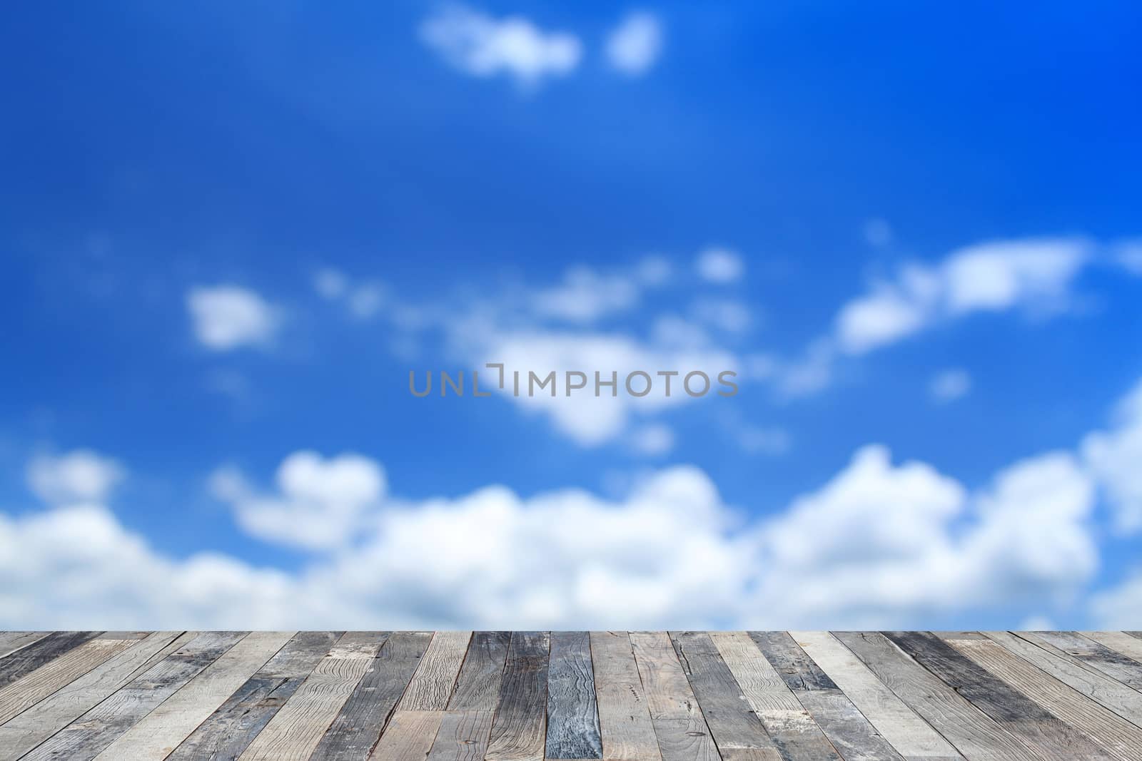 View of the blue sky above a wooden floor