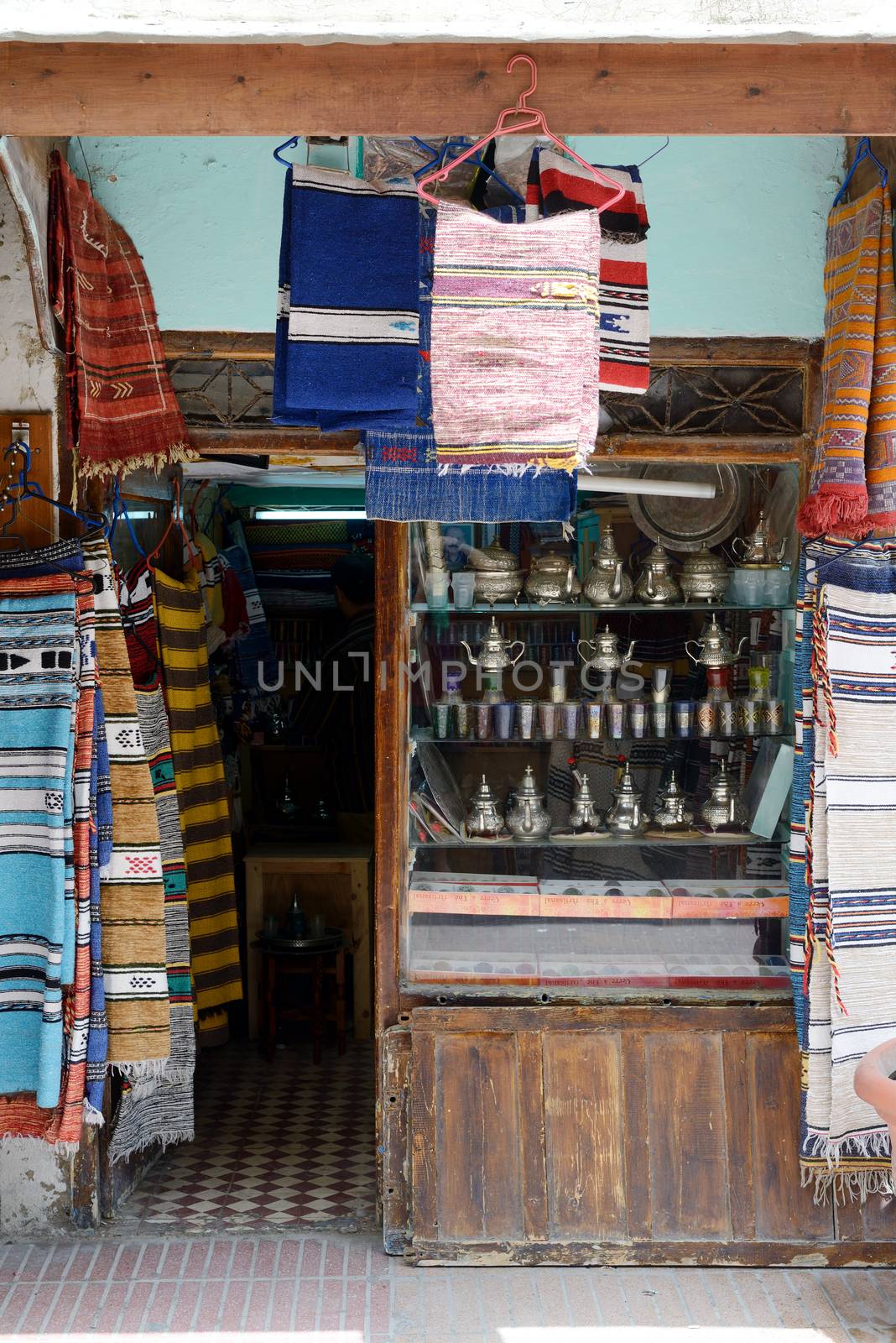 Morocco shop front with rugs and traditional tea pots and cups on display