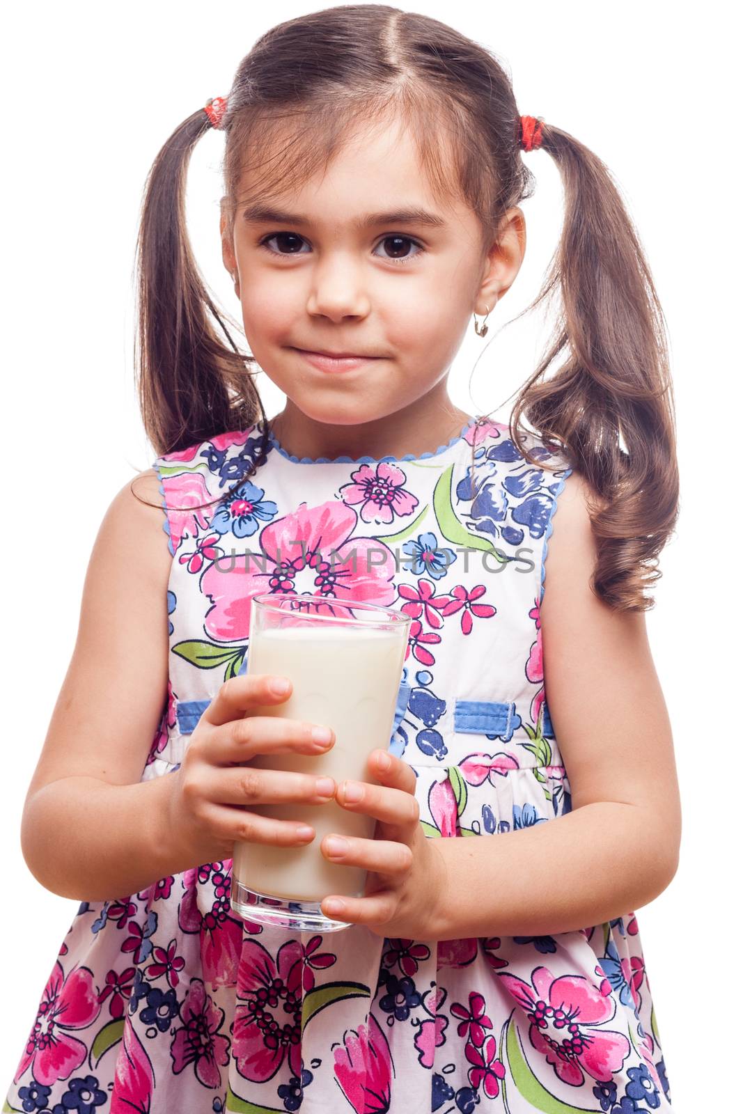 Young girl drinking milk out of glass on white background