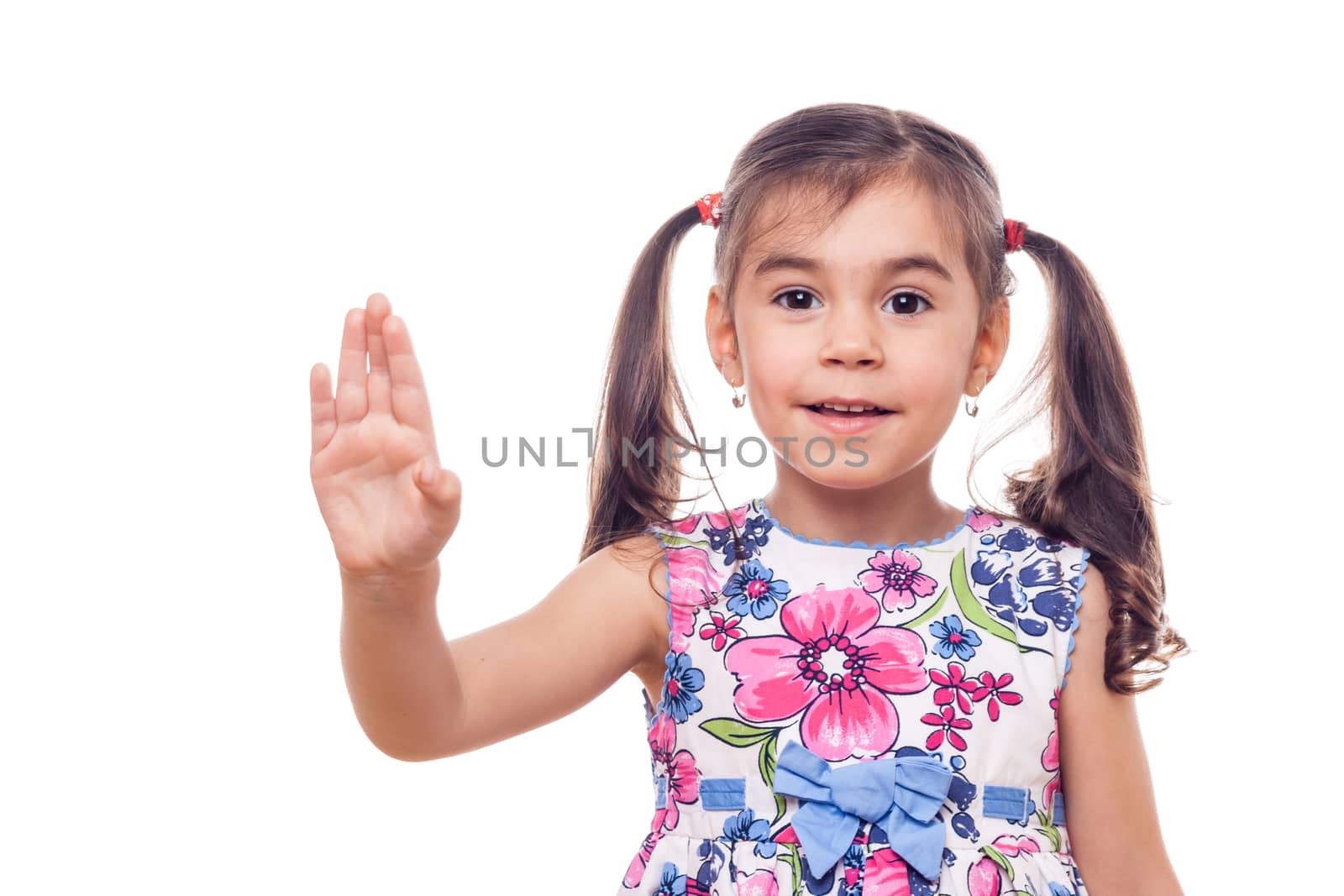 young girl on white background waving at camera