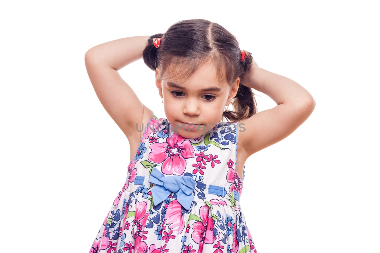 young girl on white background arranging her hair