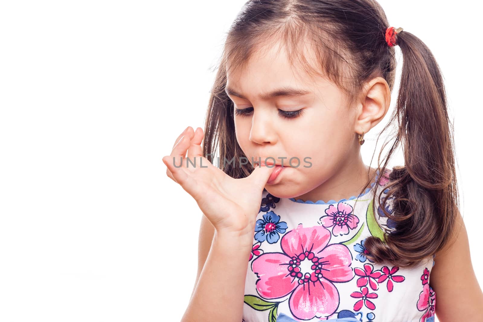 young girl on white background licking finger