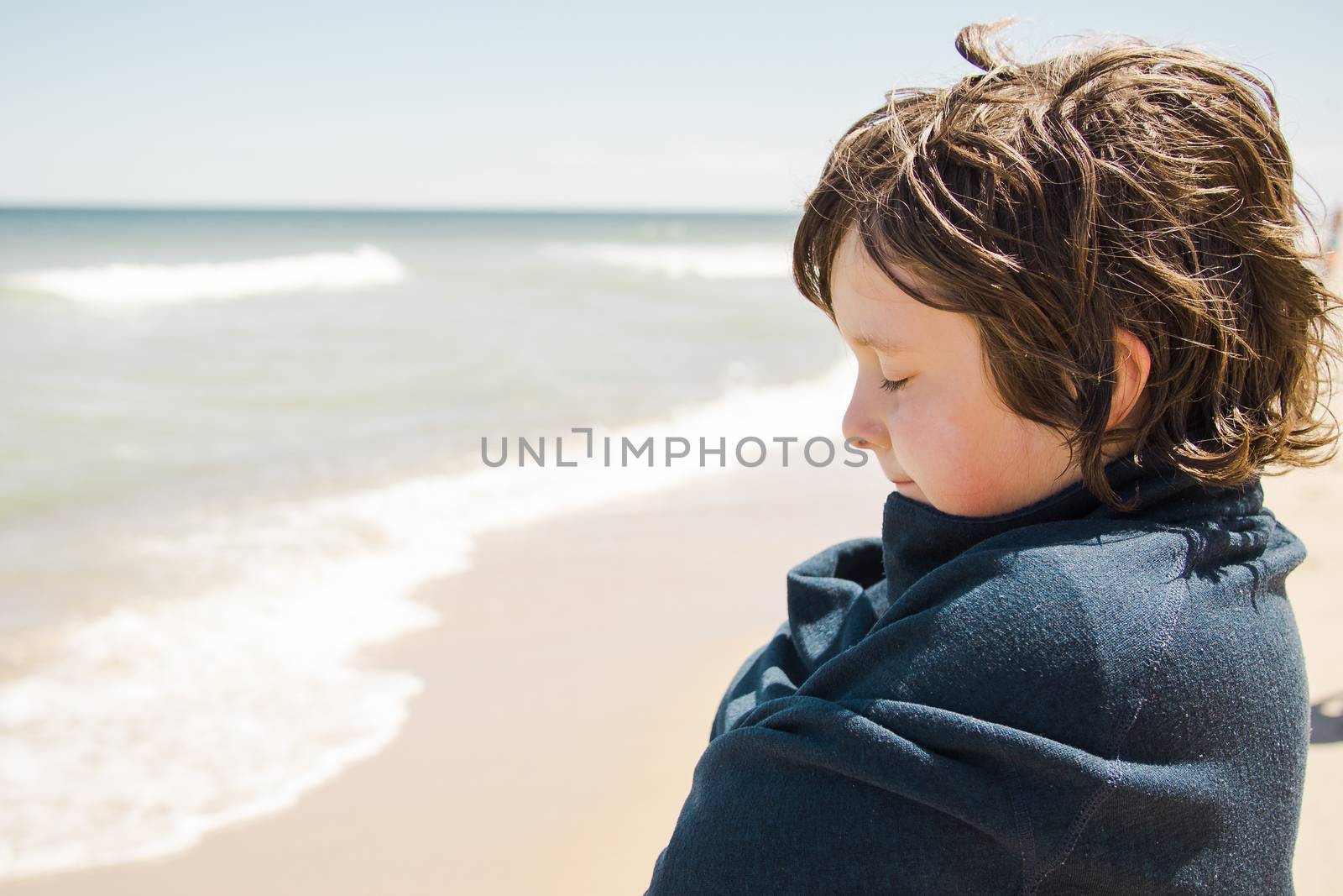 Boy standing on the beach and relaxing in Cape Cod