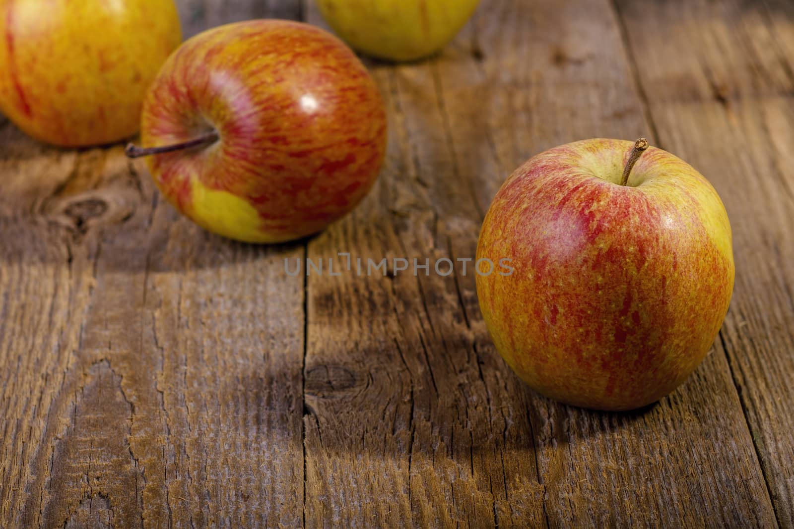 apples on a wooden table by manaemedia