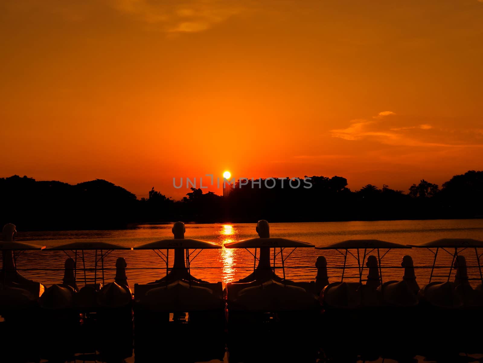 The bike boat at orange sky by golengstock