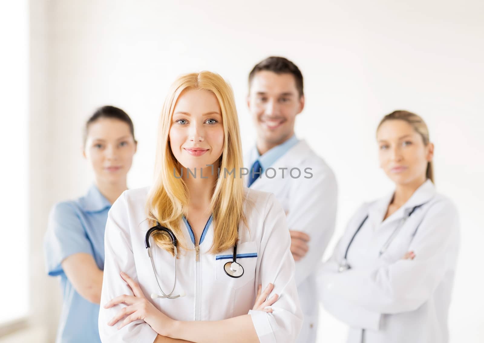 female doctor in front of medical group by dolgachov