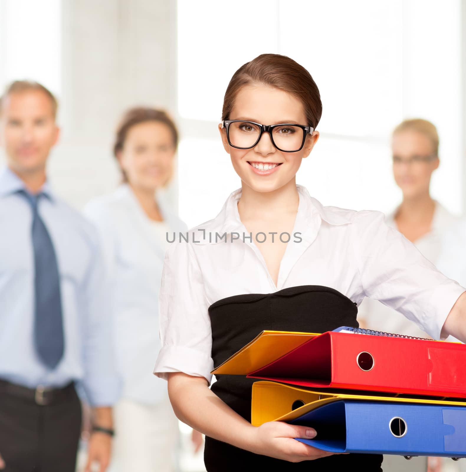 young attractive businesswoman with folders by dolgachov