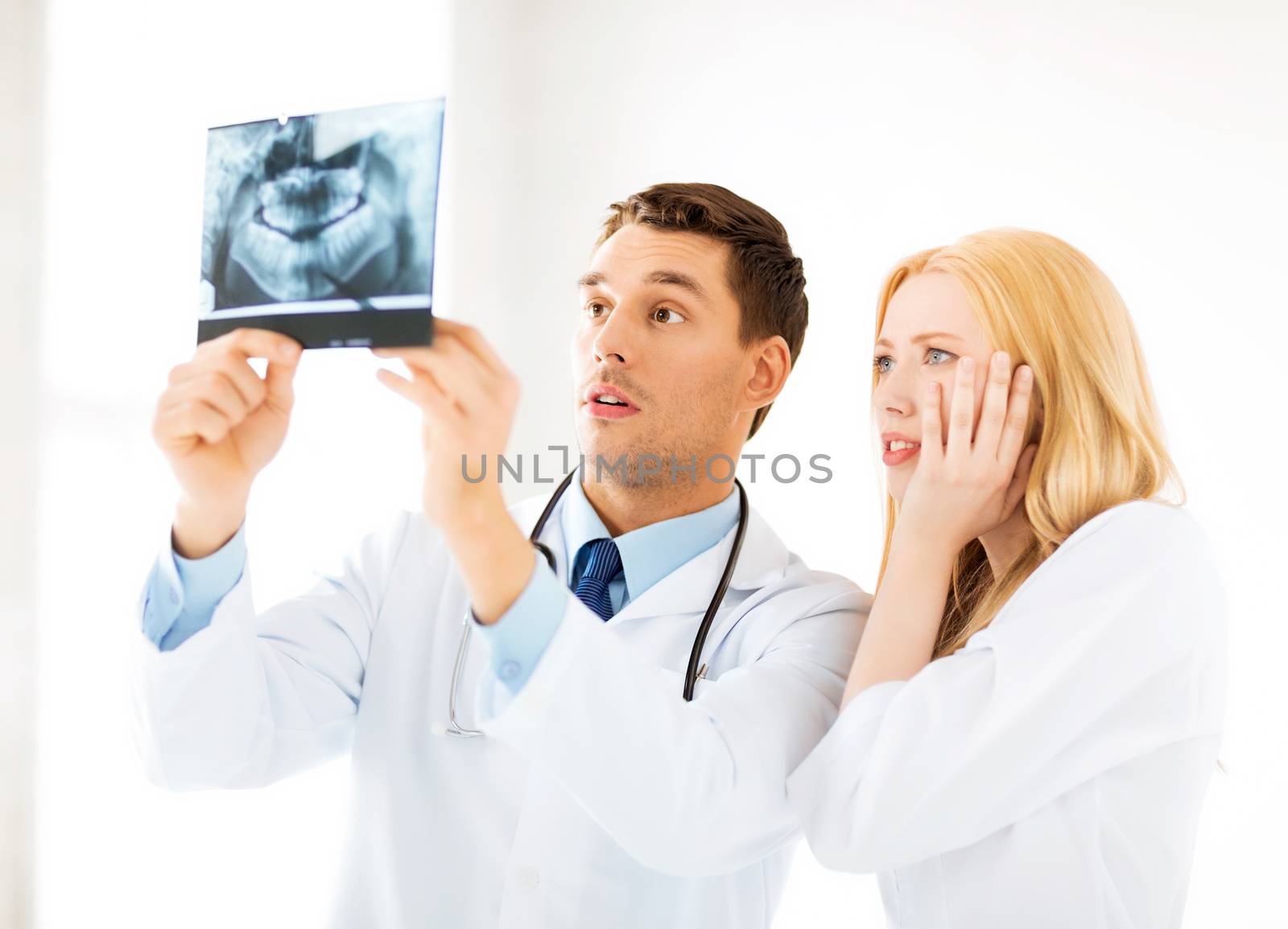 two doctors looking at x-ray by dolgachov