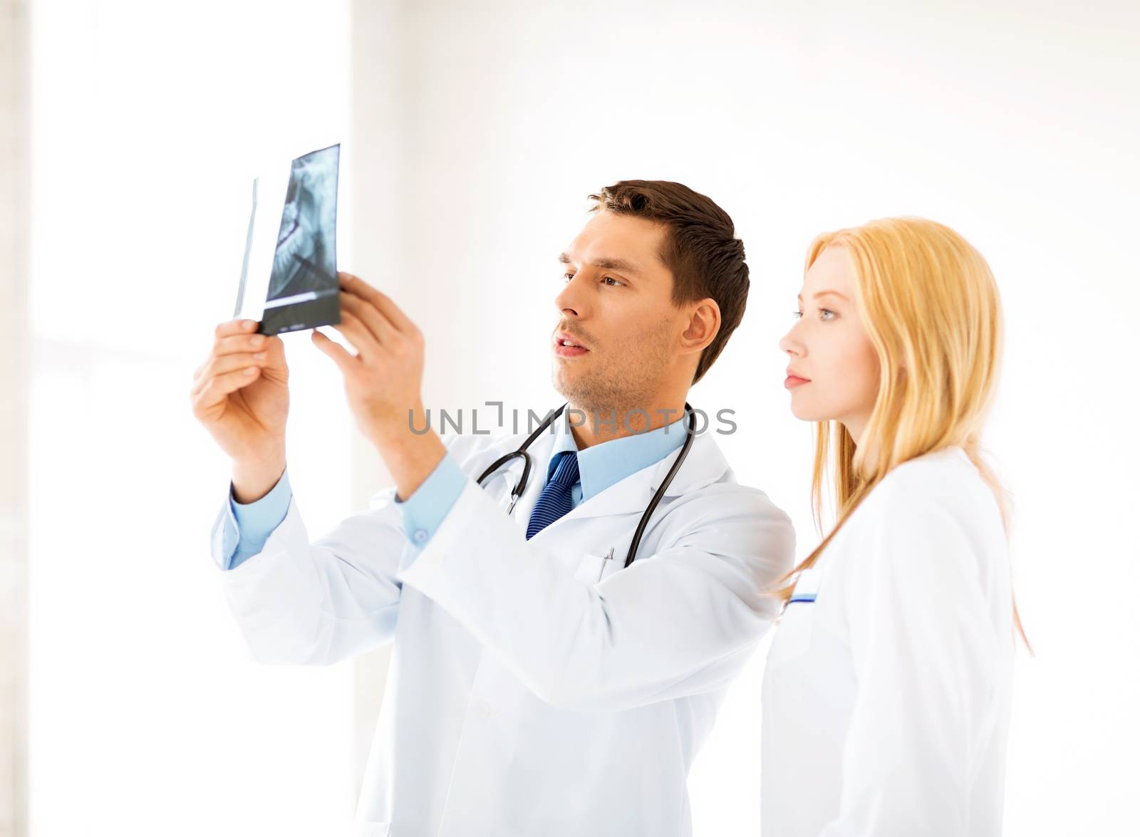 two doctors looking at x-ray by dolgachov