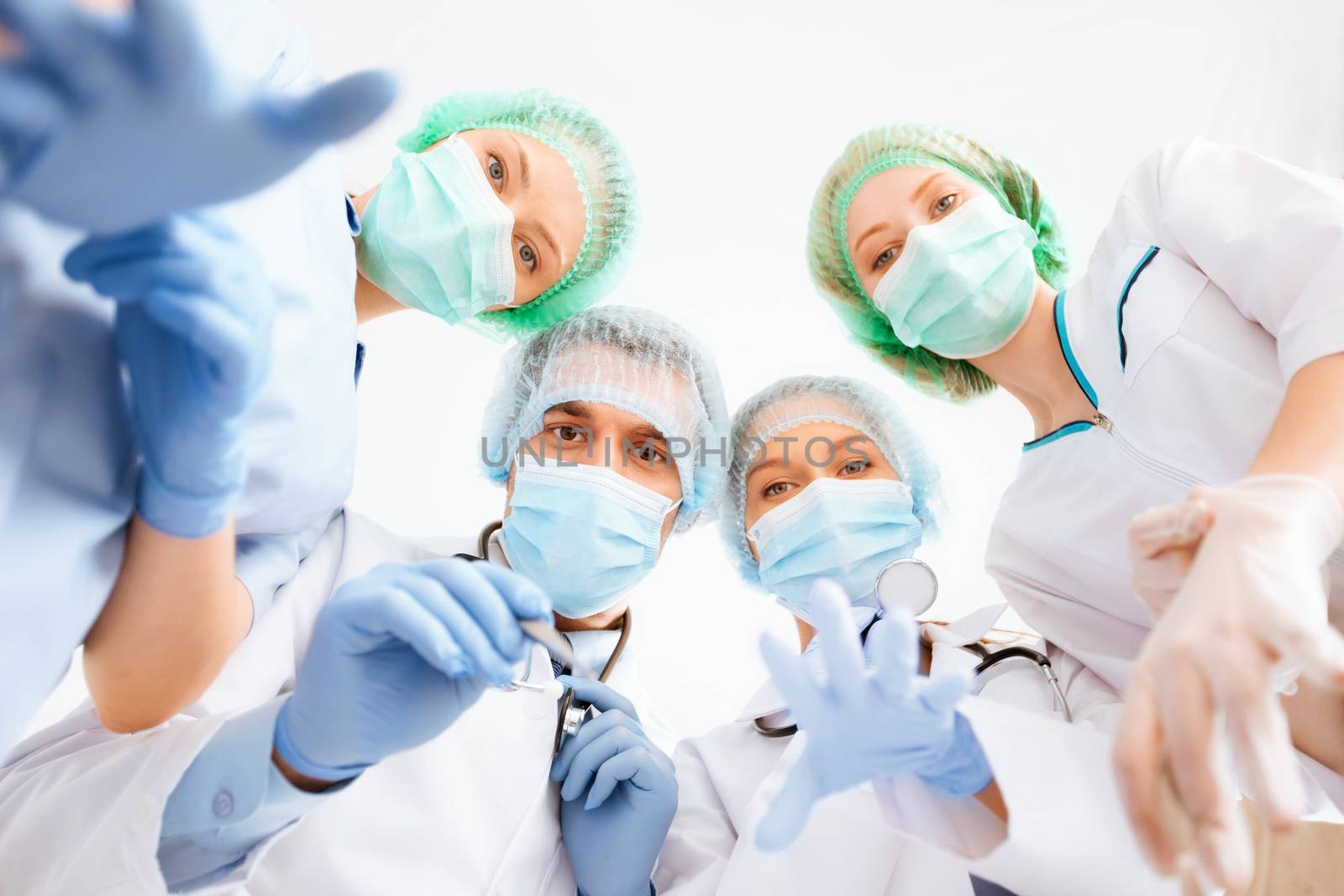 group of doctors in operating room by dolgachov