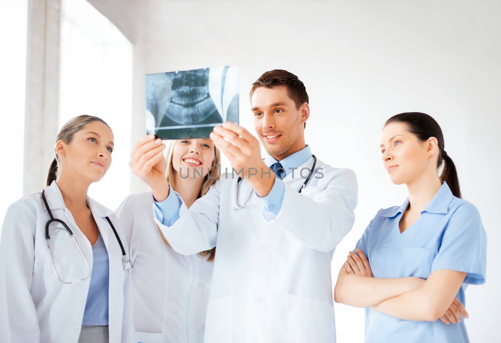 young group of doctors looking at x-ray by dolgachov