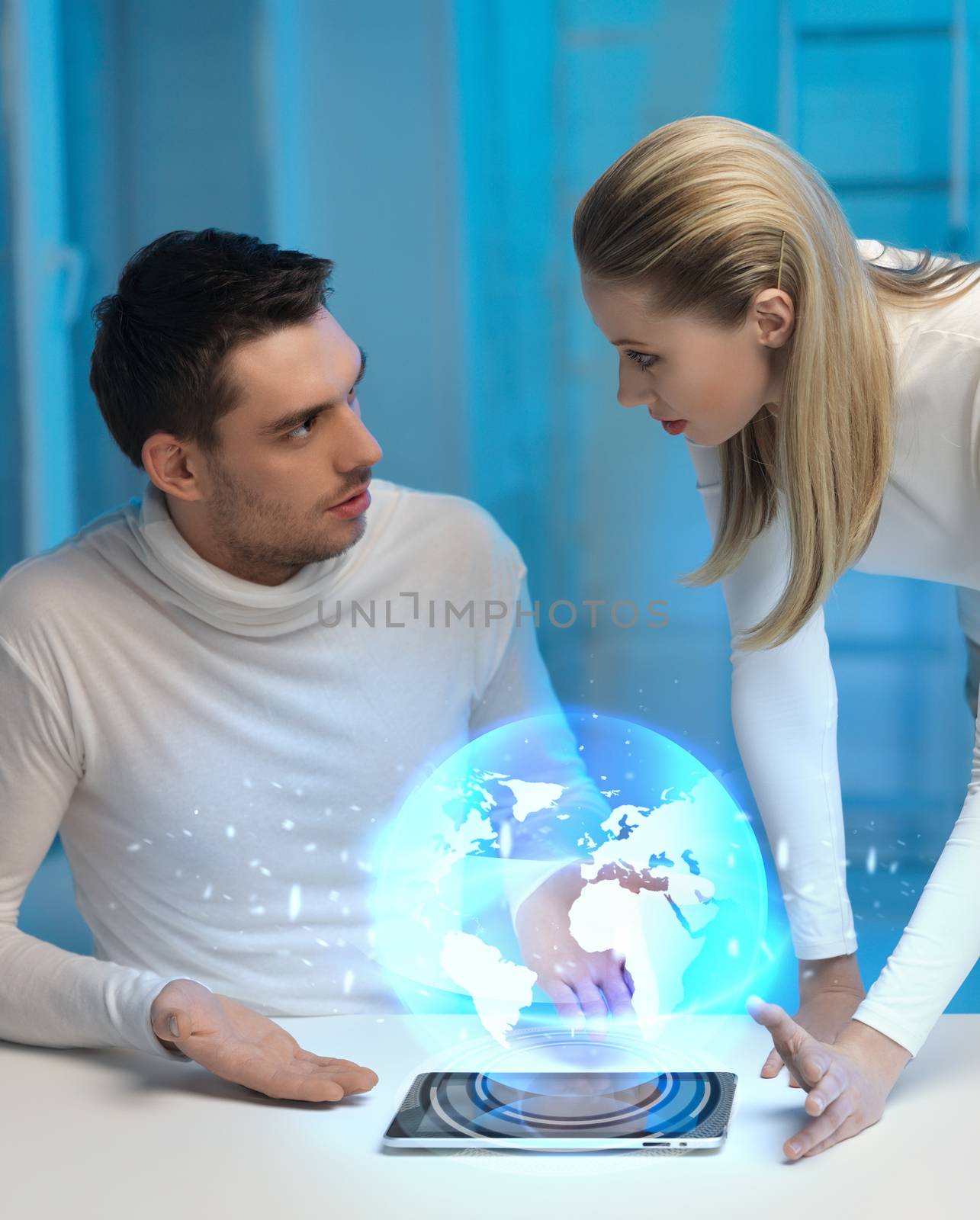 picture of futuristic man and woman with globe hologram