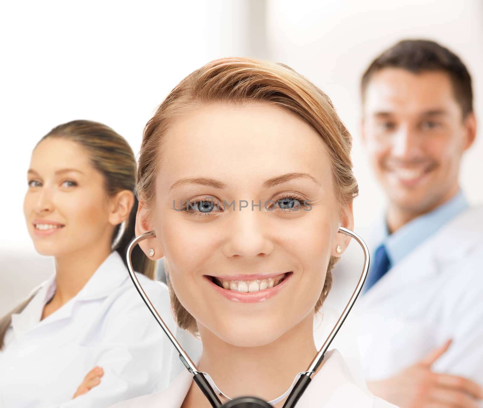 attractive female doctor with stethoscope by dolgachov