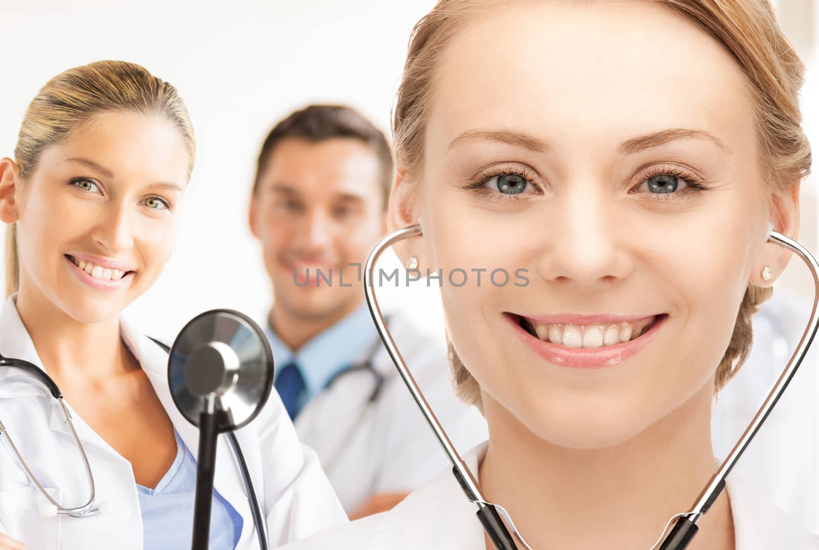 attractive female doctor with stethoscope by dolgachov