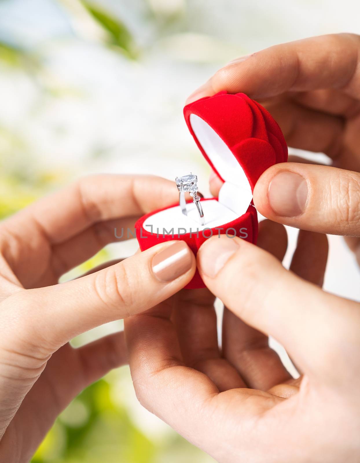 couple hands with wedding ring and gift box