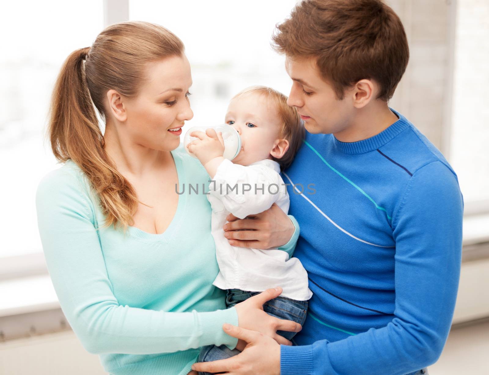 family and adorable baby with feeding-bottle by dolgachov