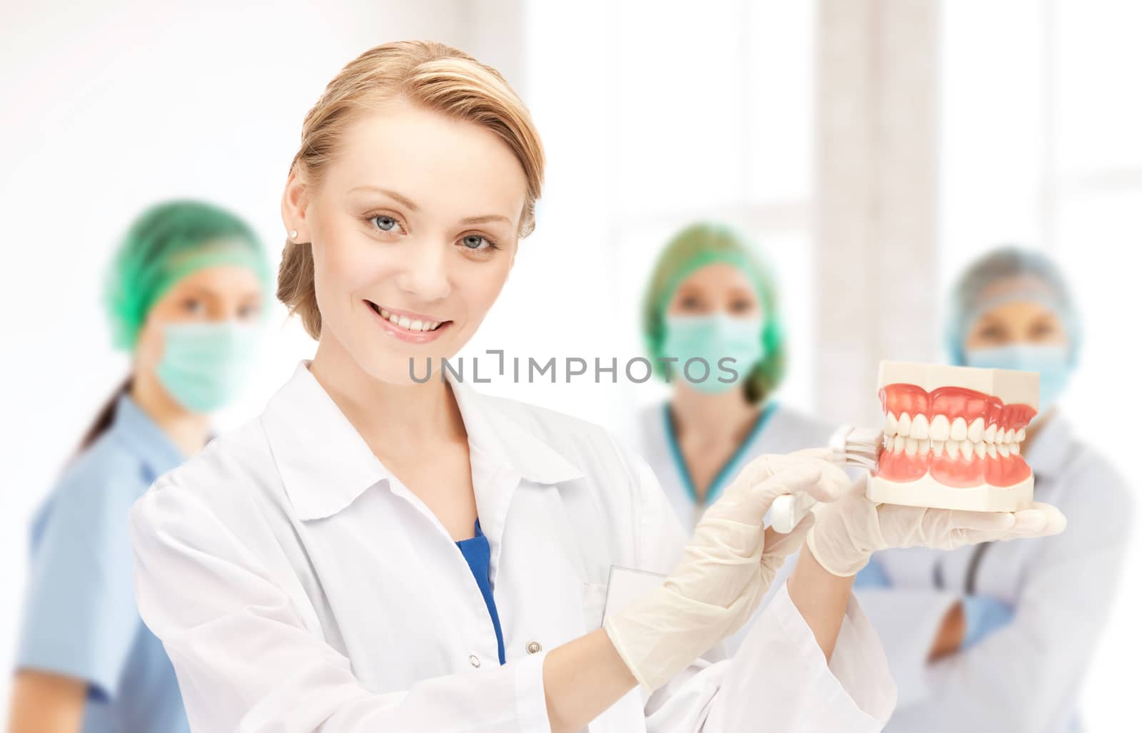 doctor with toothbrush and jaws in hospital by dolgachov