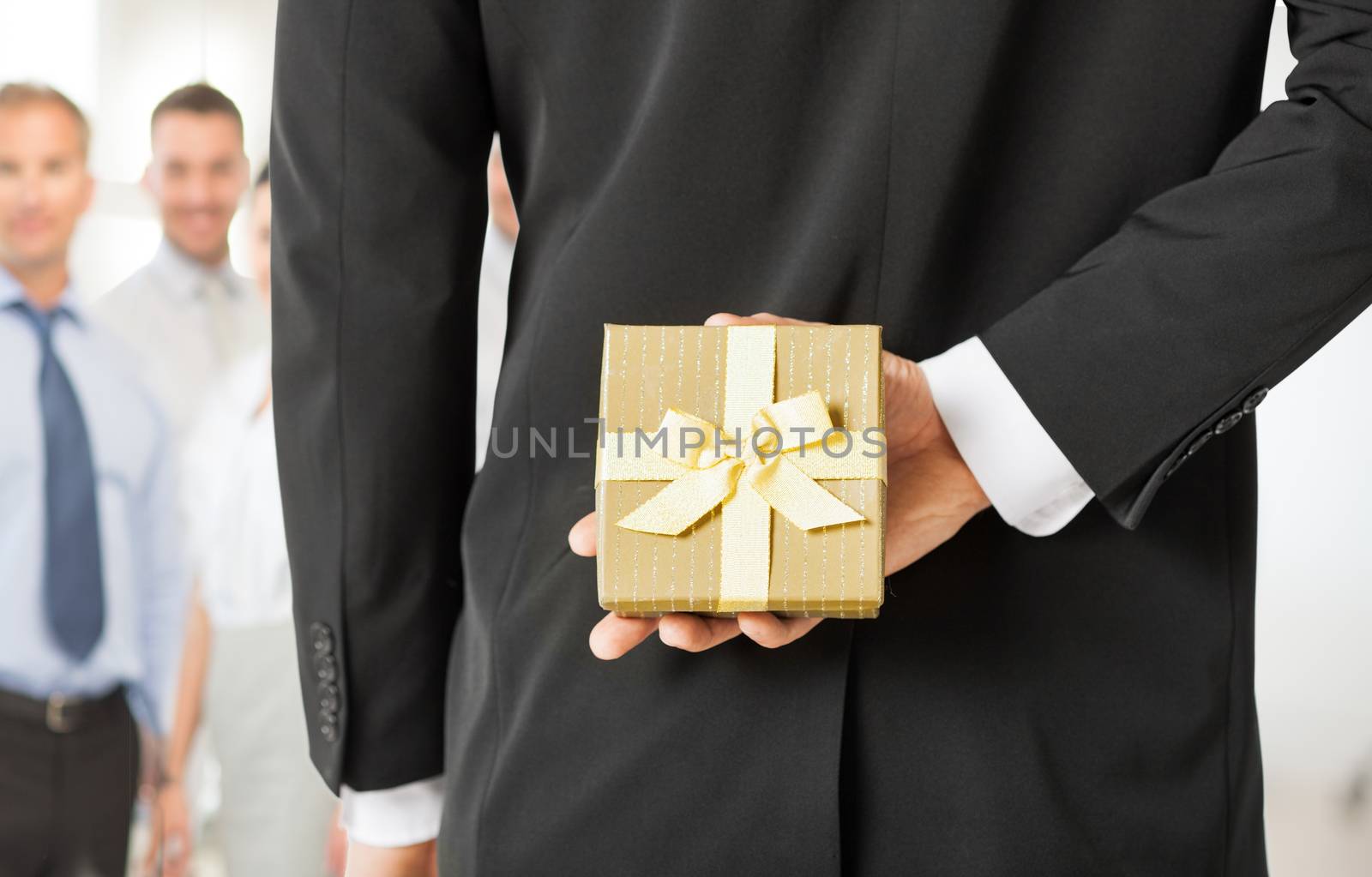 close up of man hands holding gift box in office