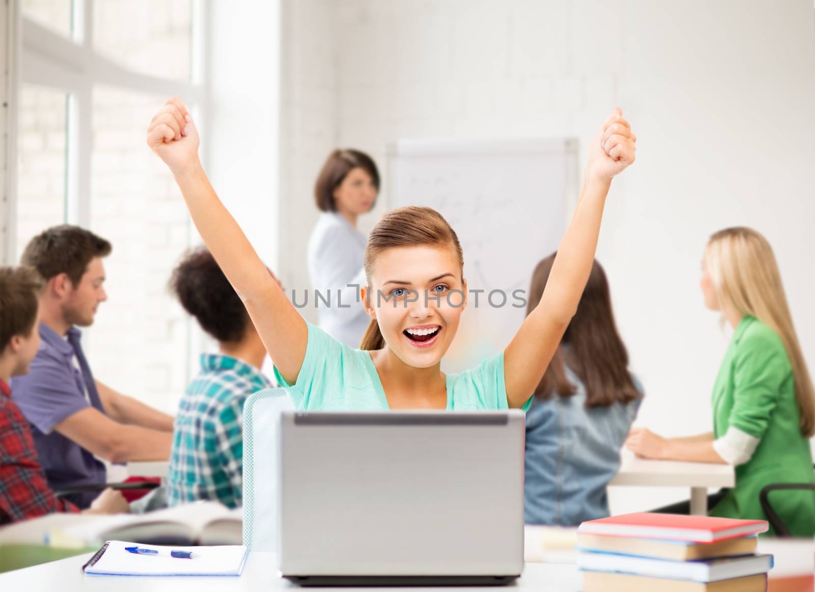 picture of happy student girl with laptop at school