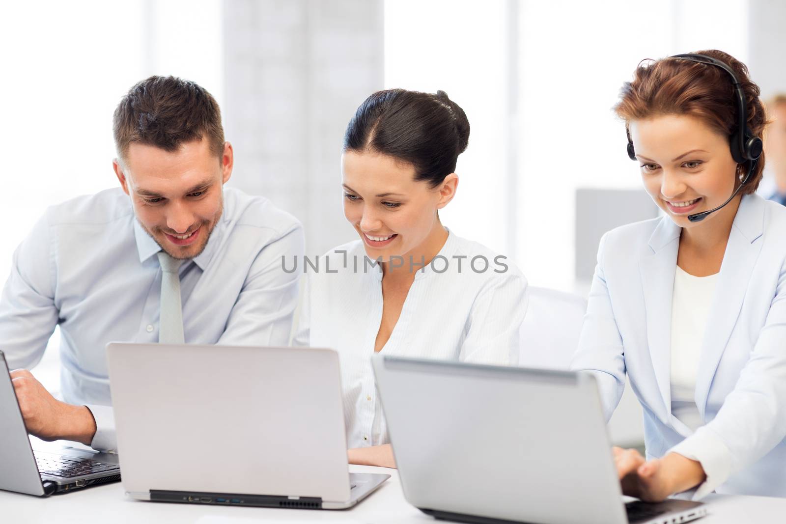 group of people working with laptops in office by dolgachov