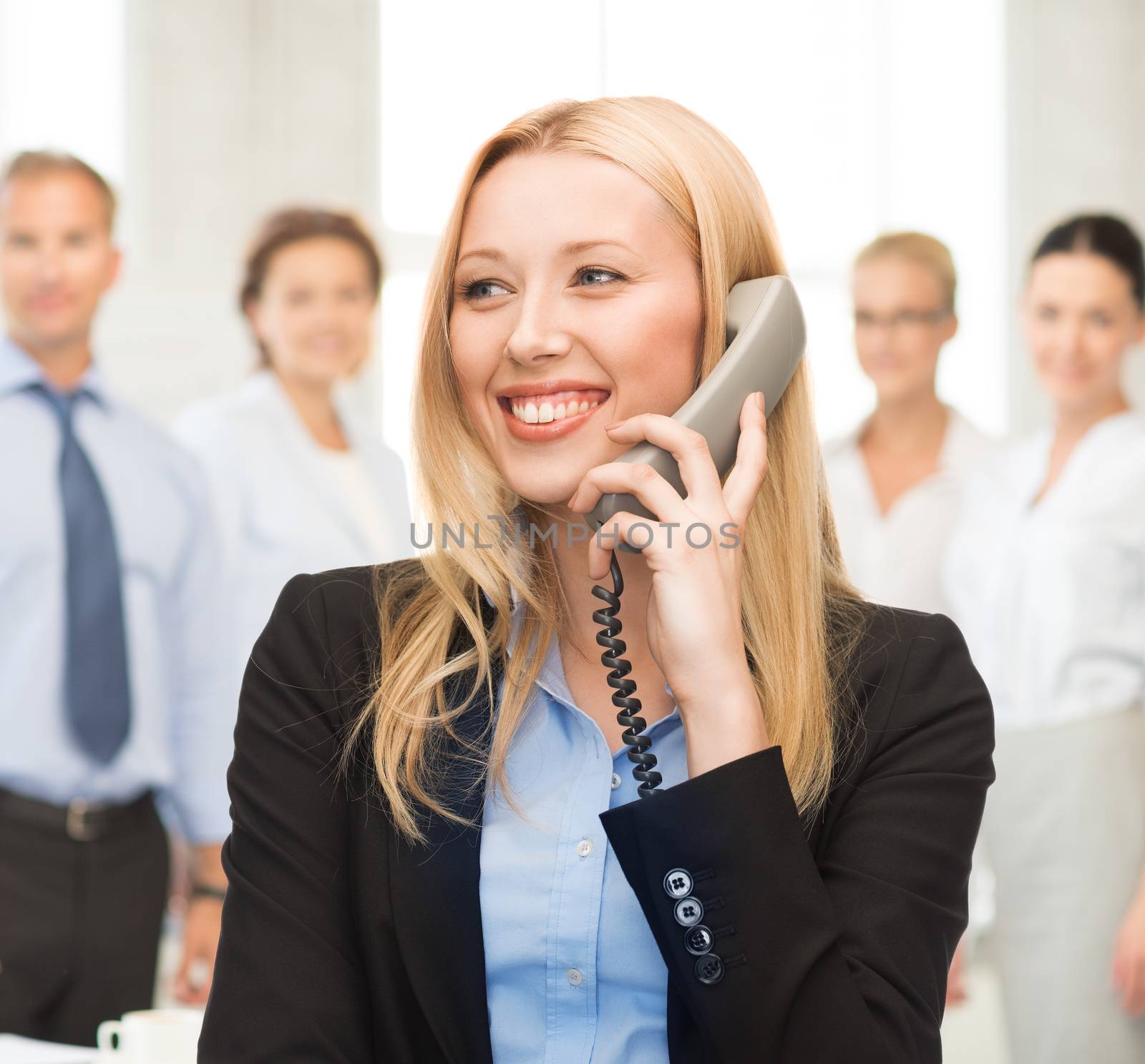 bright picture of smiling woman with phone in office