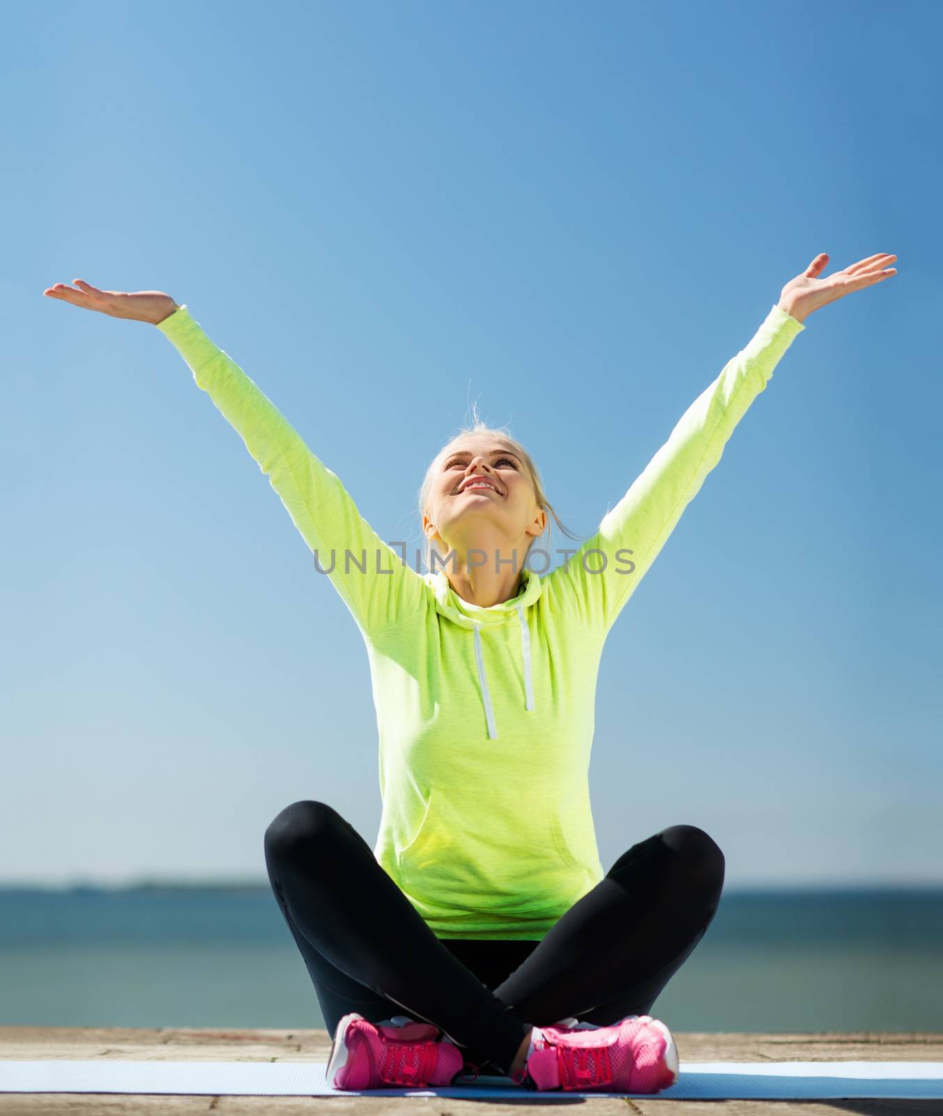 woman doing yoga outdoors by dolgachov