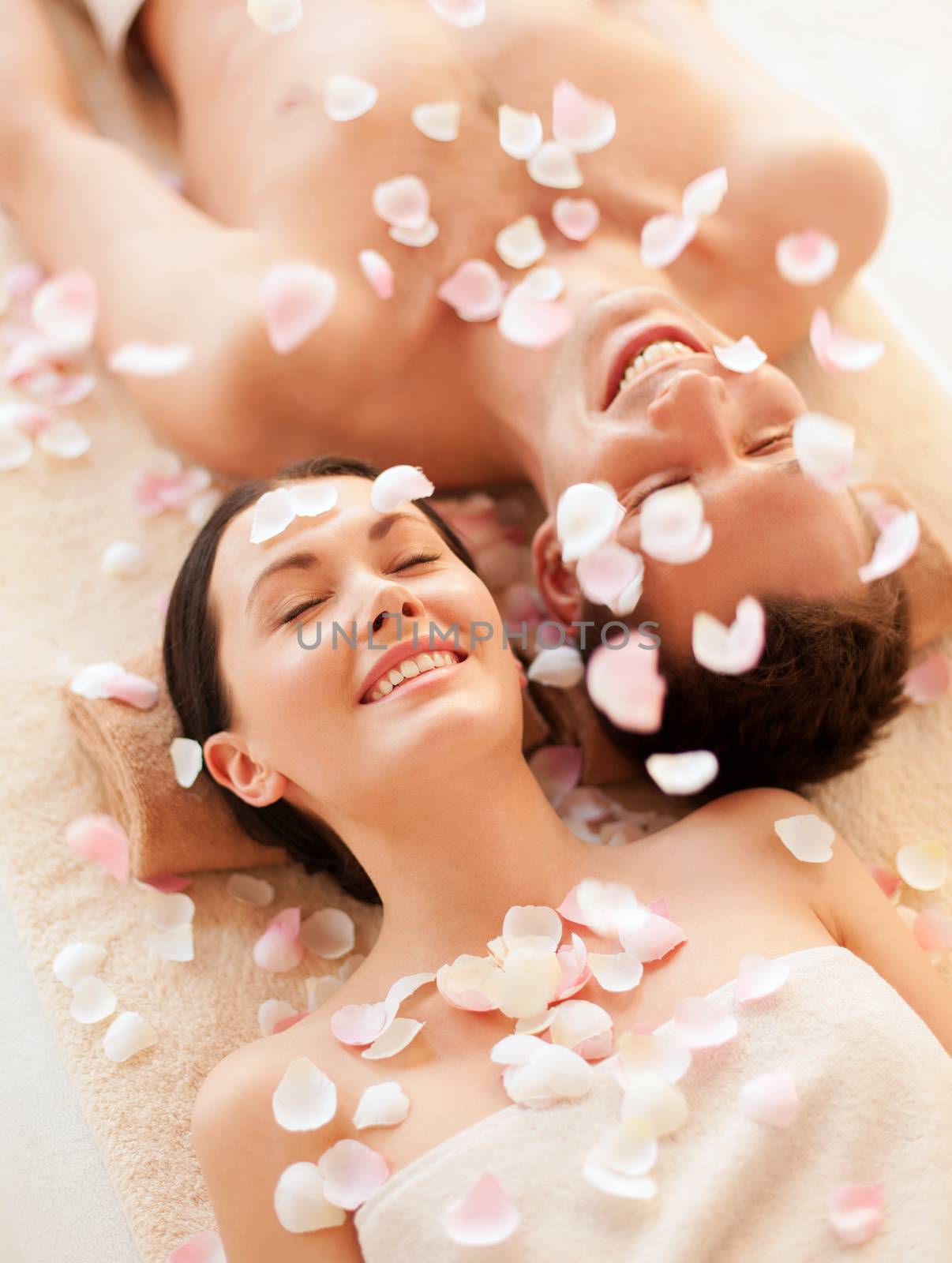 picture of couple in spa salon lying on the massage desks