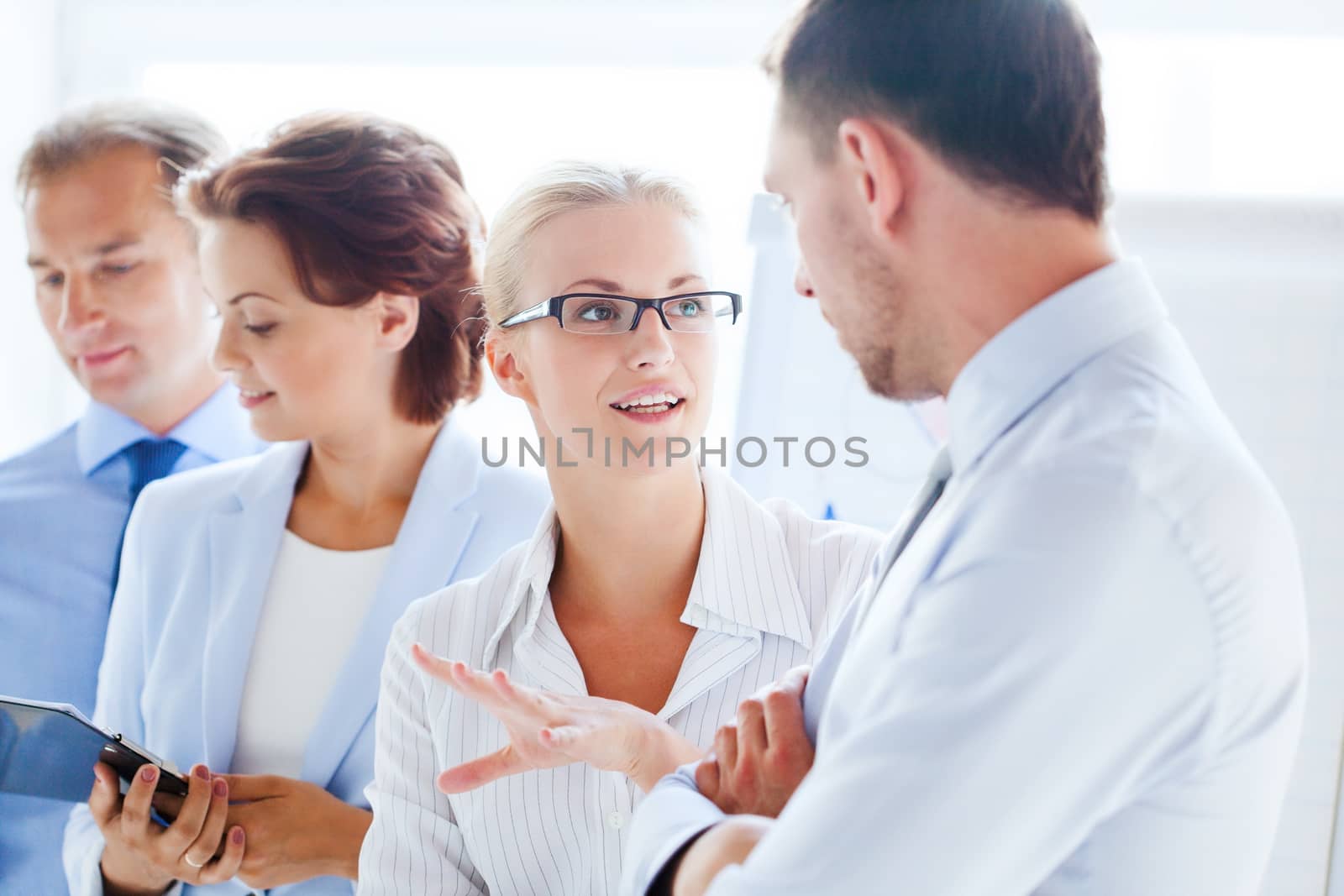 friendly businessman and businesswoman having discussion in office
