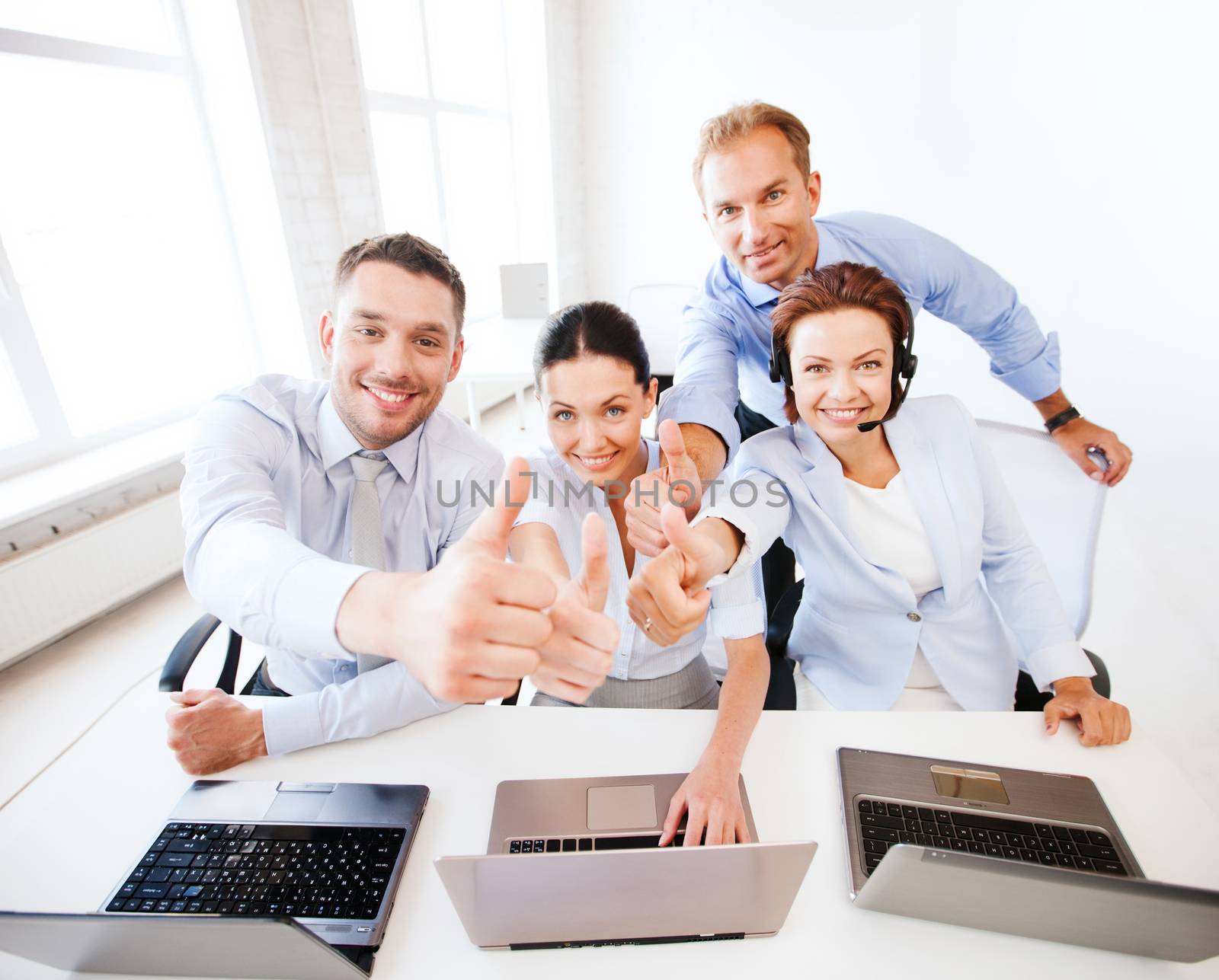 group of office workers showing thumbs up by dolgachov