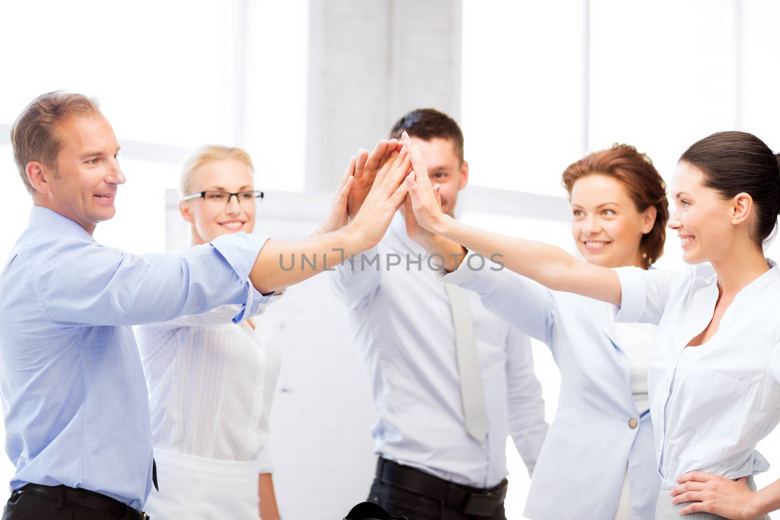 picture of happy business team celebrating victory in office