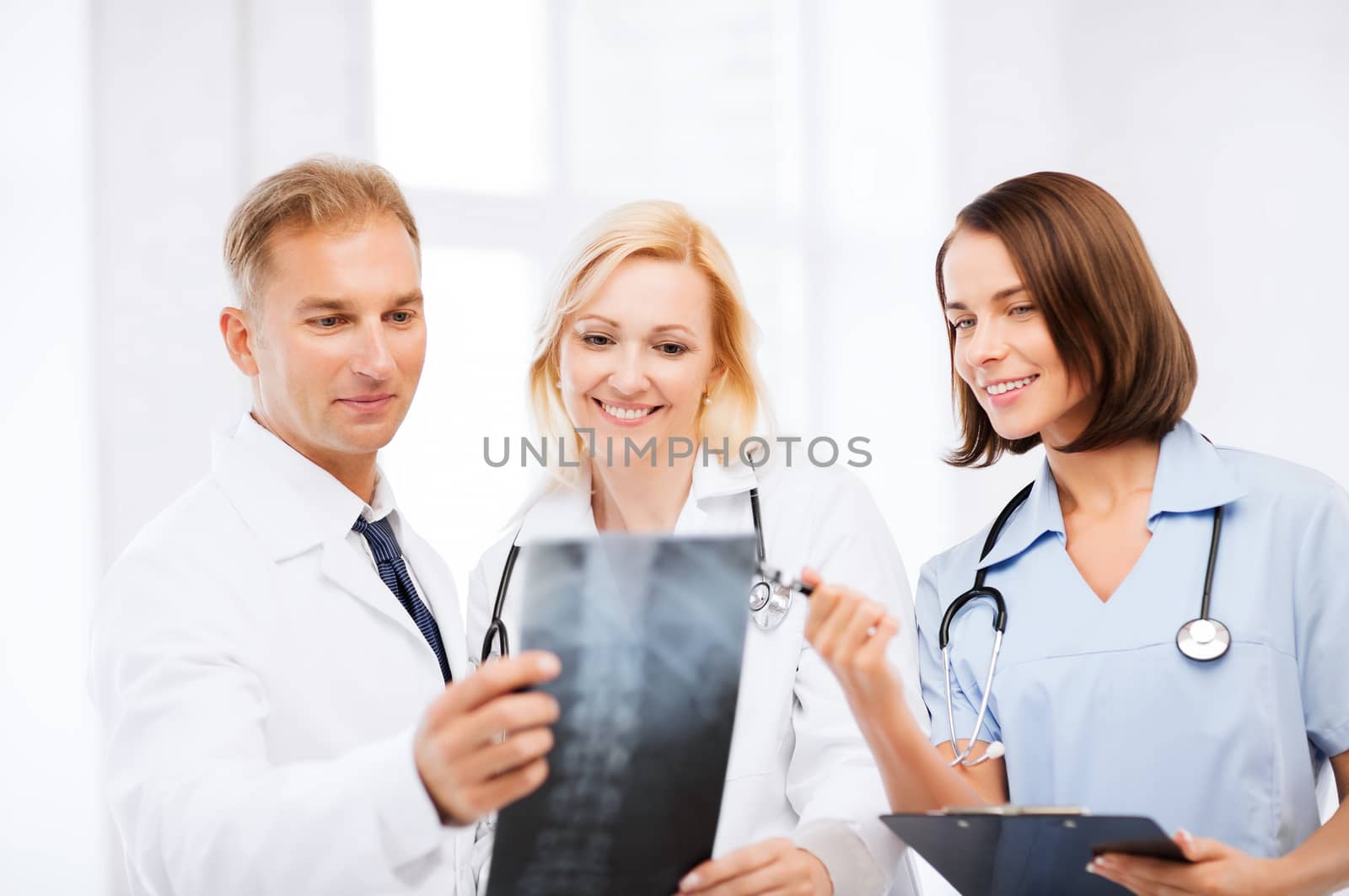 healthcare, medical and radiology concept - doctors looking at x-ray