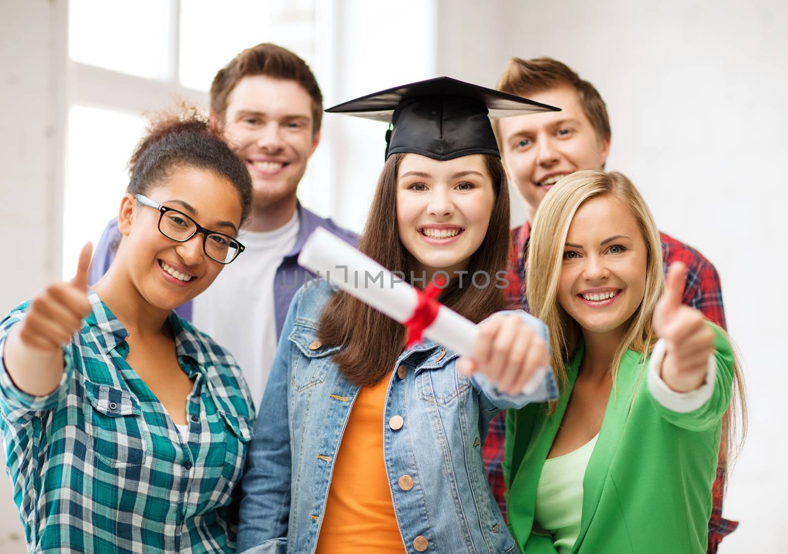 student girl in graduation cap with diploma by dolgachov