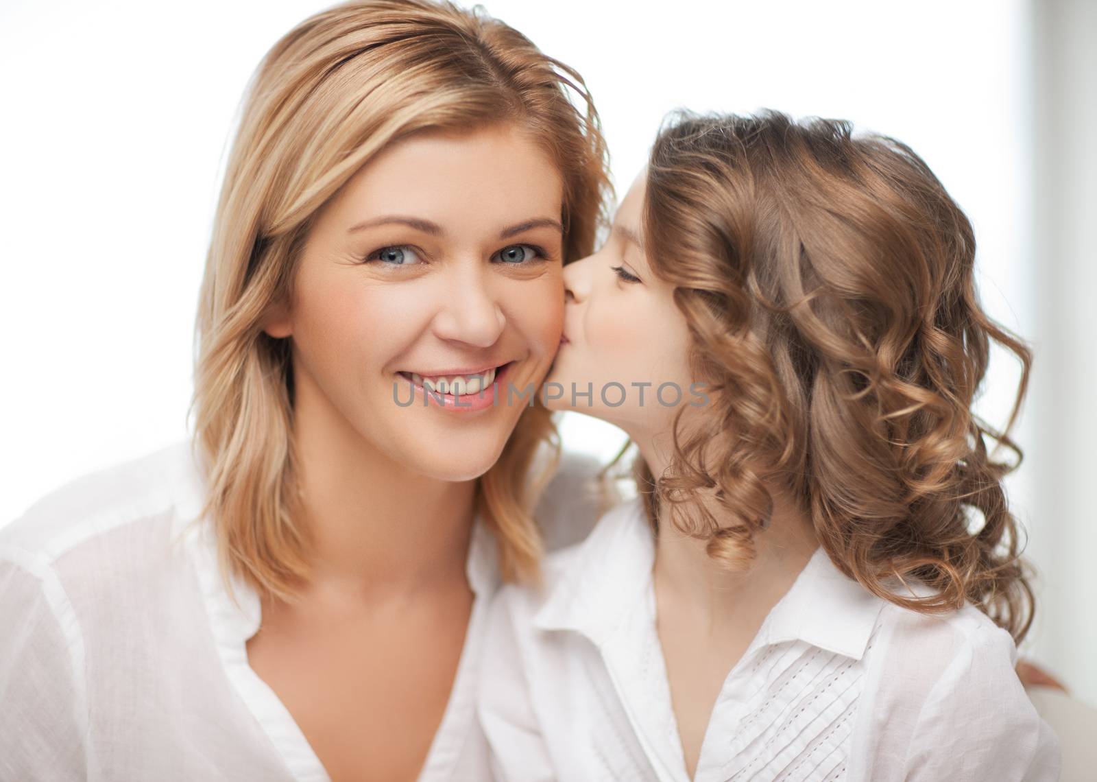 happy family - daughter kisses her mother