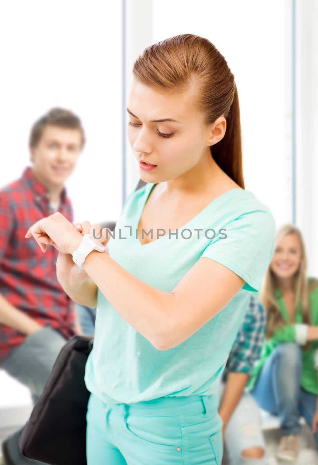 student girl looking at wristwatch by dolgachov