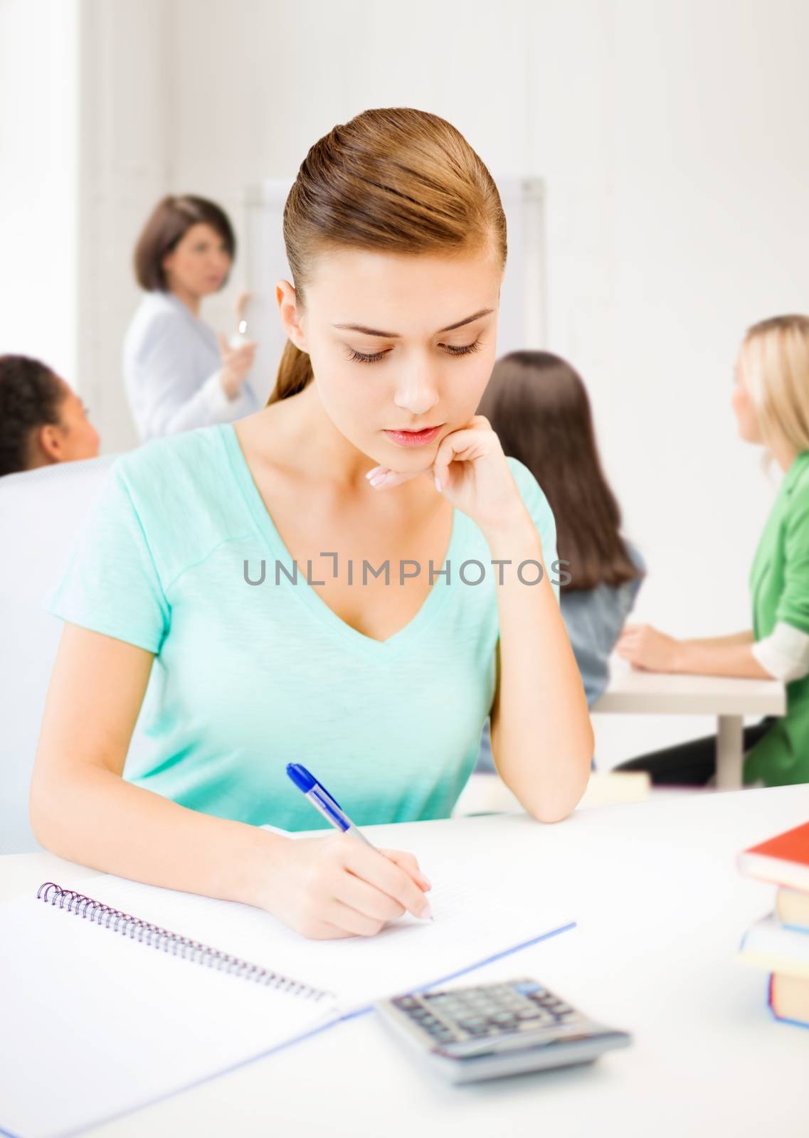 education concept - student girl with notebook and calculator
