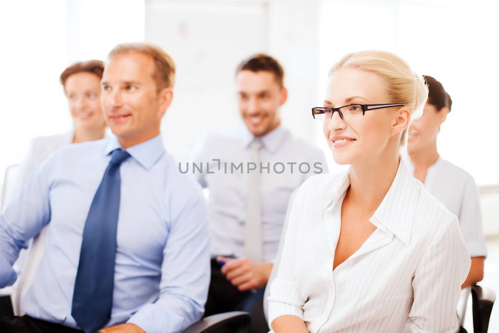 business concept - smiling businessmen and businesswomen on conference