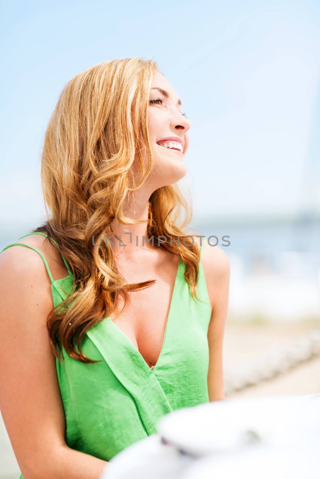 girl in cafe on the beach by dolgachov