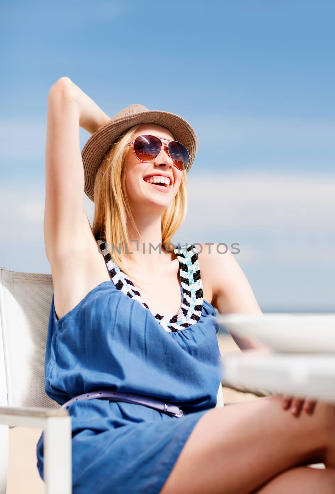 girl in shades in cafe on the beach by dolgachov