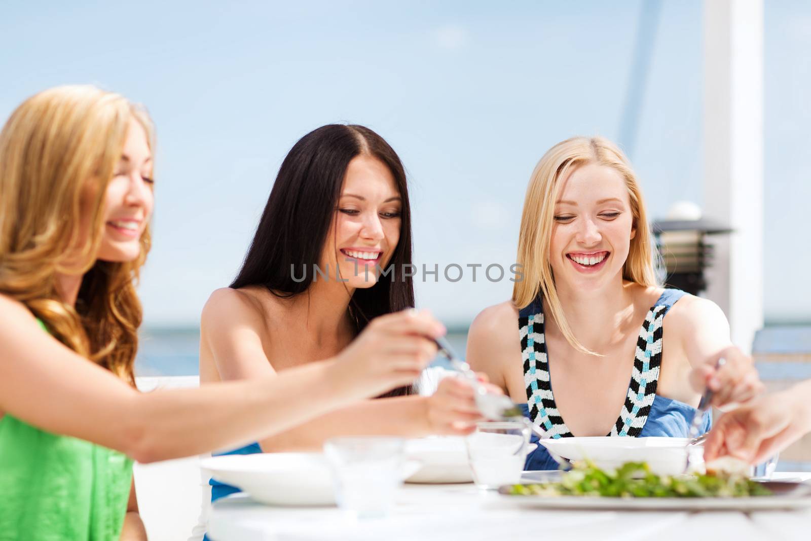 girls in cafe on the beach by dolgachov