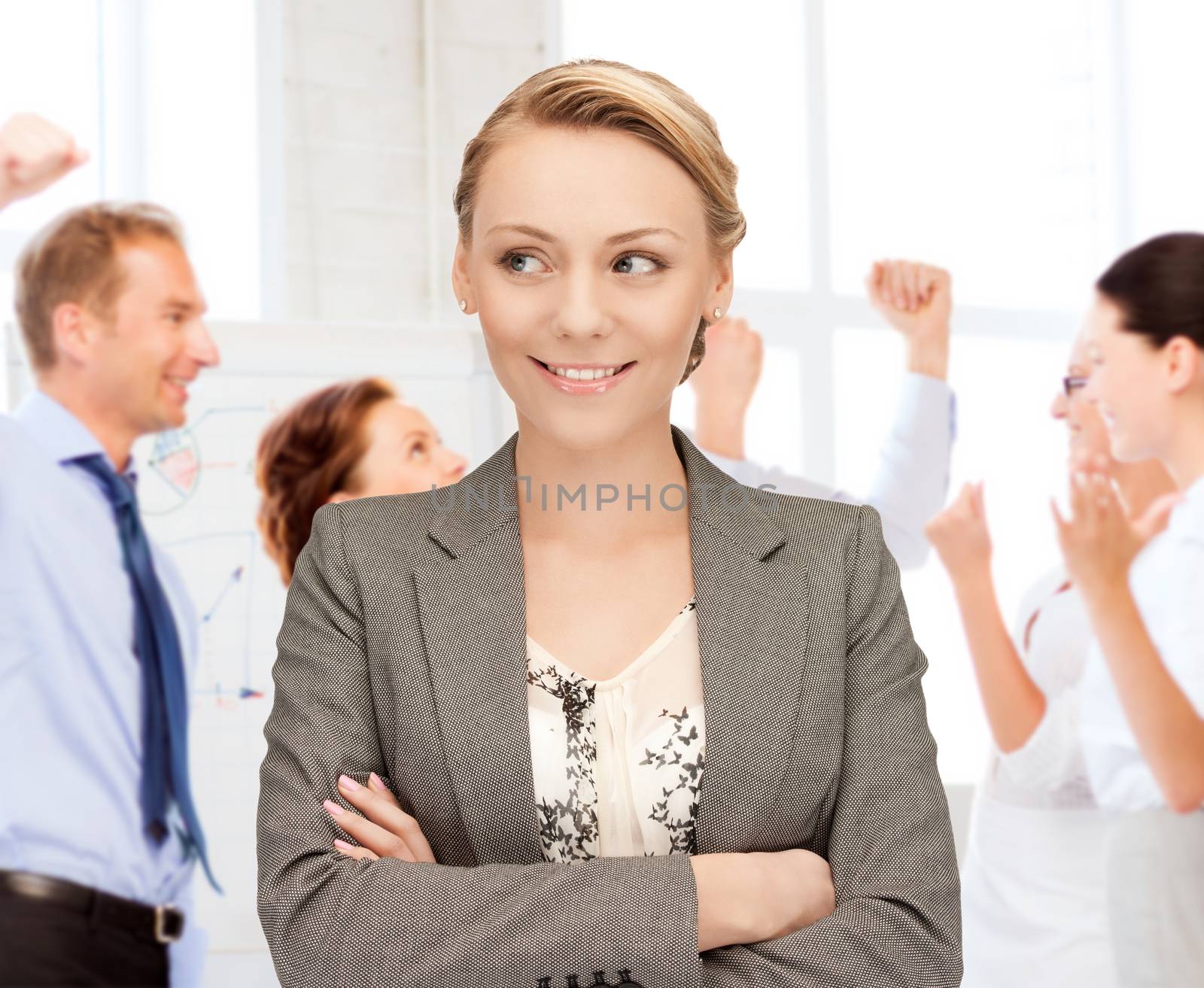 businesswoman celebrating succes in office by dolgachov