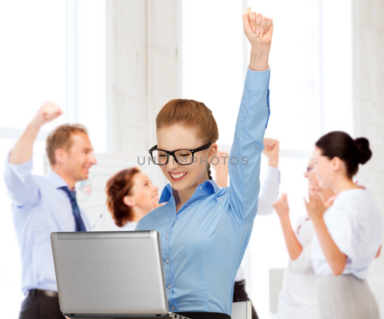 business and success - happy businesswoman with computer in office
