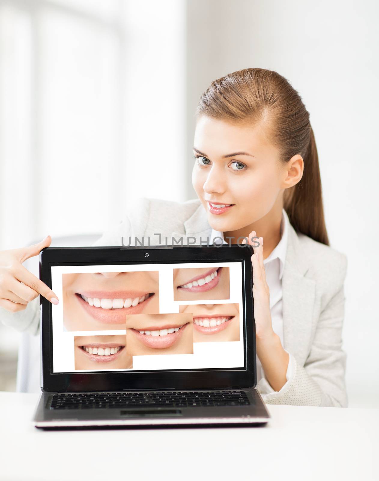 healthcare, medical and stomatology - woman with laptop and smiles